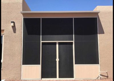 Sunscreen patio enclosure on a residential building.