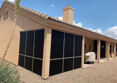 House with large screened patio enclosure.