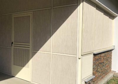 House exterior with beige siding and brick accent.