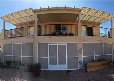 House with pergola and garage doors.