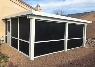 White aluminum screen room attached to a house.