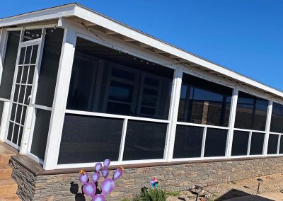 Sunroom addition on house with decorative cactus sculpture.