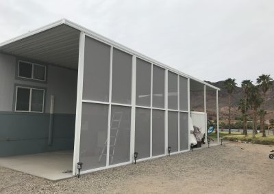 Modern screened patio enclosure, desert mountain background.