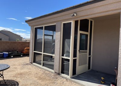 Suburban home with screened patio and clear blue sky.