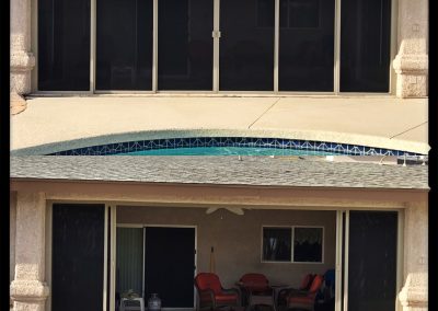 House with pool reflection in glass doors.