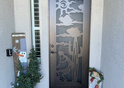 Front door with holiday decorations and welcome mat.