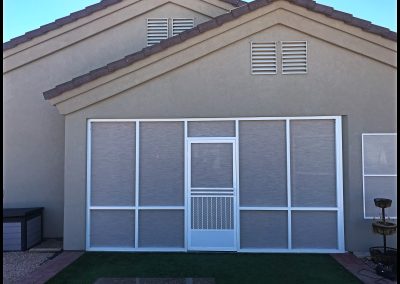 Suburban house with screened patio enclosure.