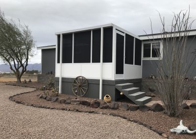 Desert house with enclosed porch and southwestern decor.