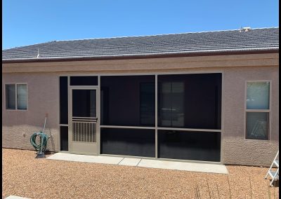 House exterior with screened patio and solar panels.