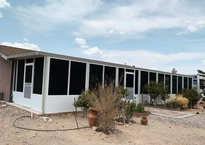 Screened porch on modern house with desert landscaping