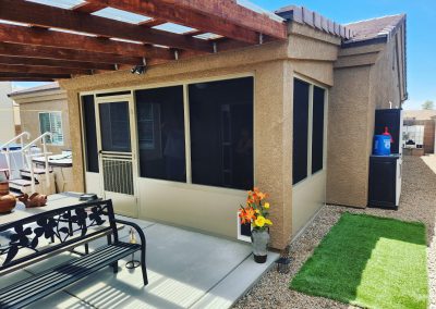 Patio with pergola, seating, and artificial grass.