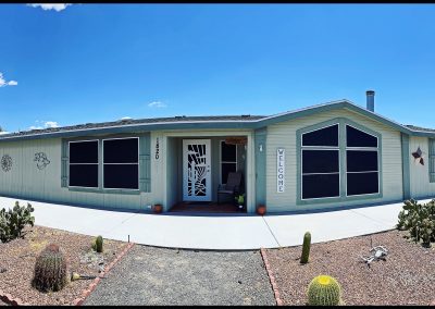 Suburban house with cacti landscaping under blue sky.