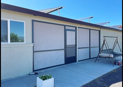 House exterior with solar panels and patio.