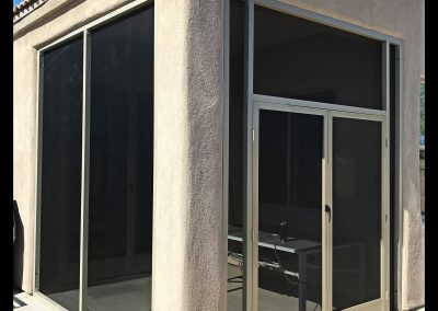 Sliding glass patio doors on a house facade.