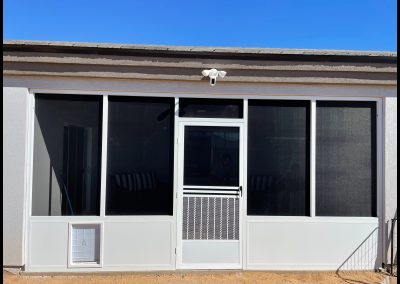 Modern house exterior with screened patio door.