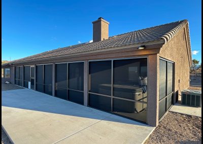 House with screened patio and terracotta tile roof.