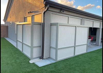 Backyard with artificial grass and modern patio cover.