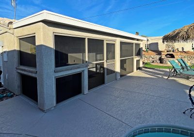 Backyard patio with screened enclosure and pool.