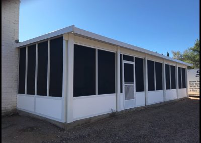 Screened porch addition to a building.