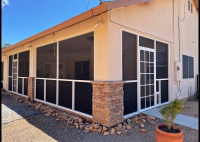 Screened patio enclosure at suburban home.