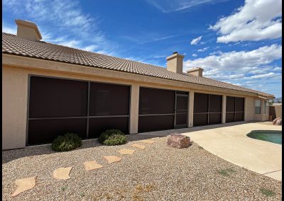 House with pool and solar screens on windows.